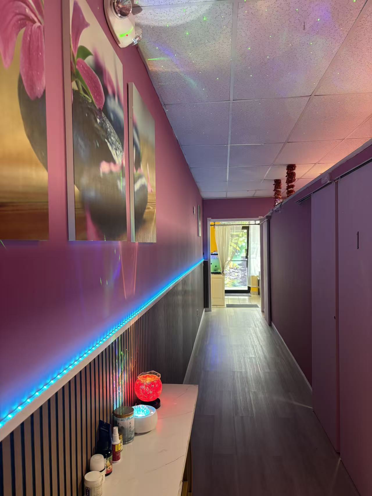 Softly lit hallway leading to the private treatment rooms
