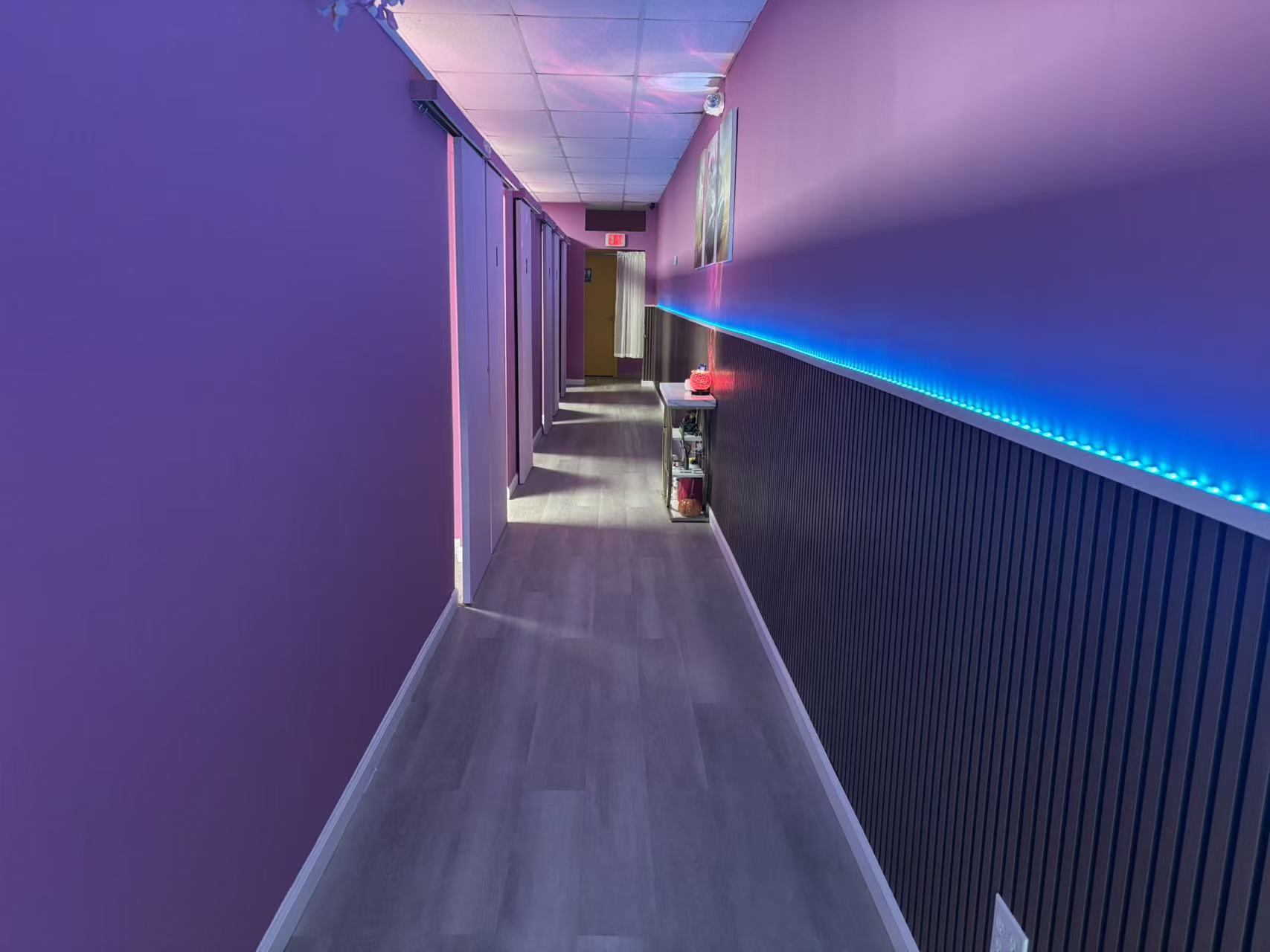 Hallway with accent lighting and private massage rooms