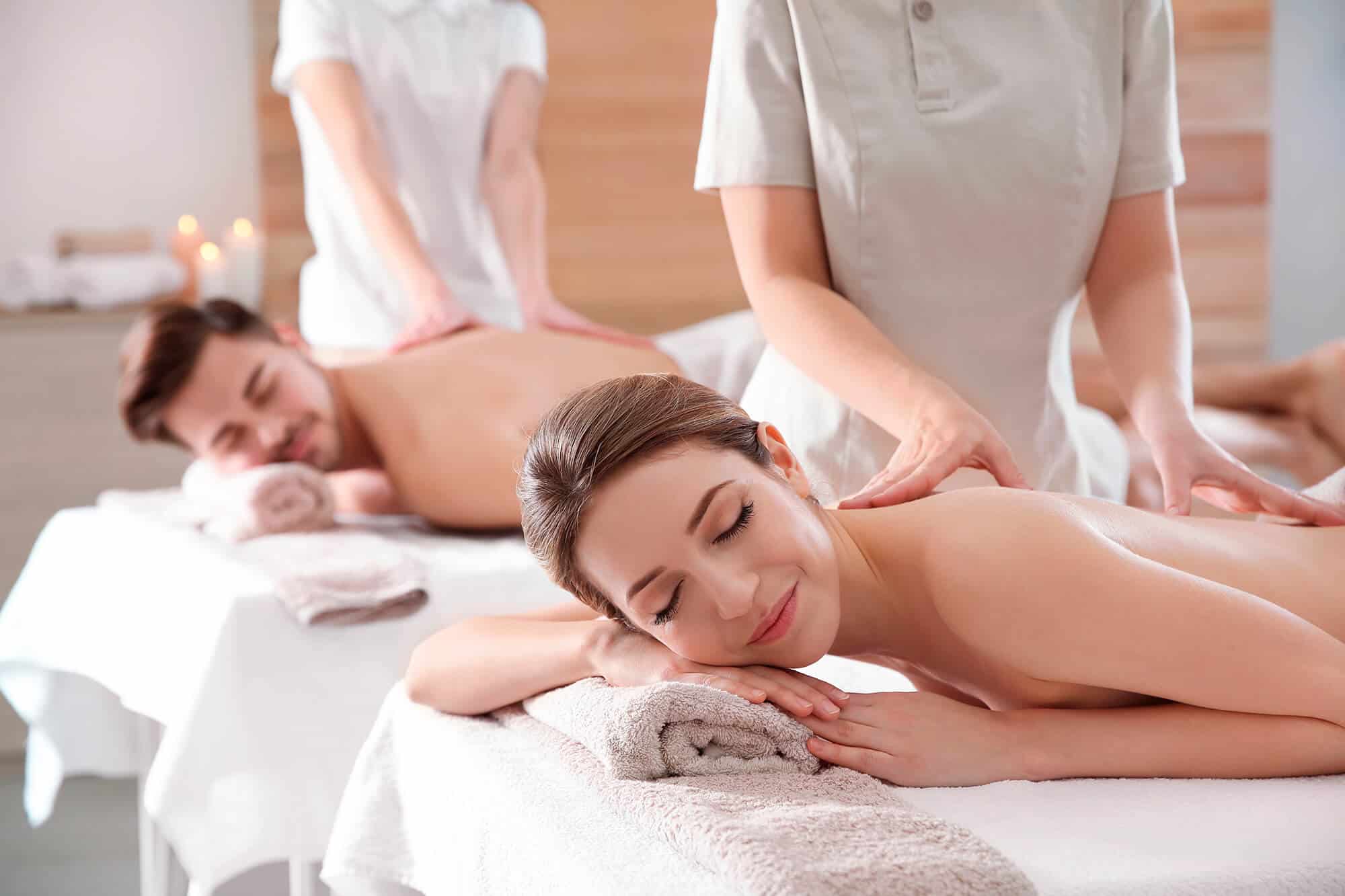 Candlelit couples treatment room with two massage tables side by side