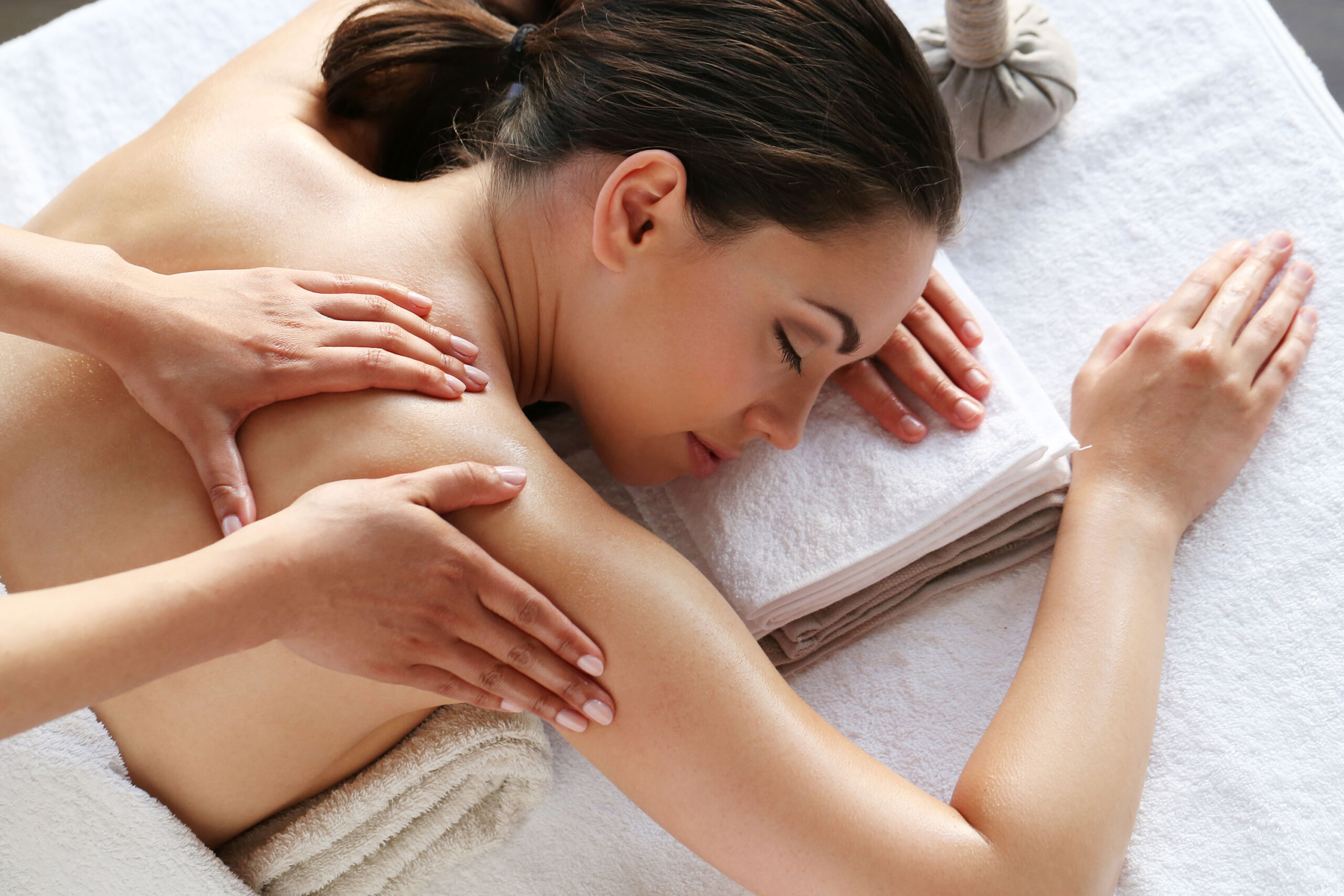 Massage table with warm oil and fresh towels prepared for a Swedish massage
